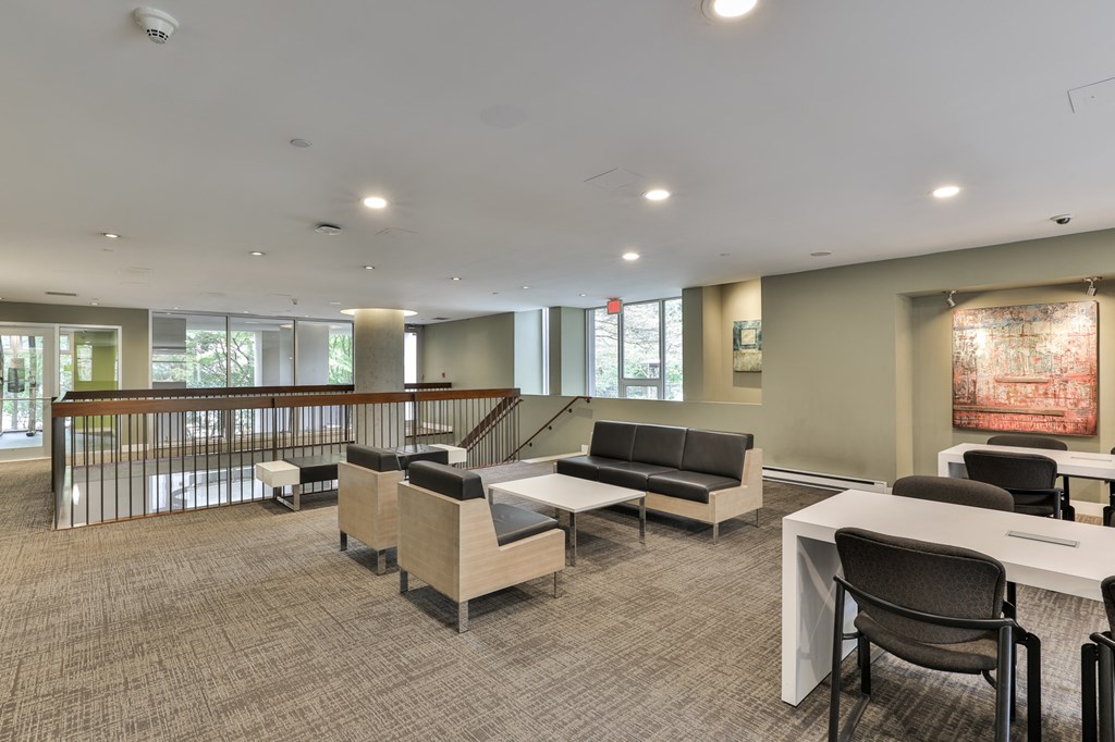 a large room with tables and chairs and a staircase