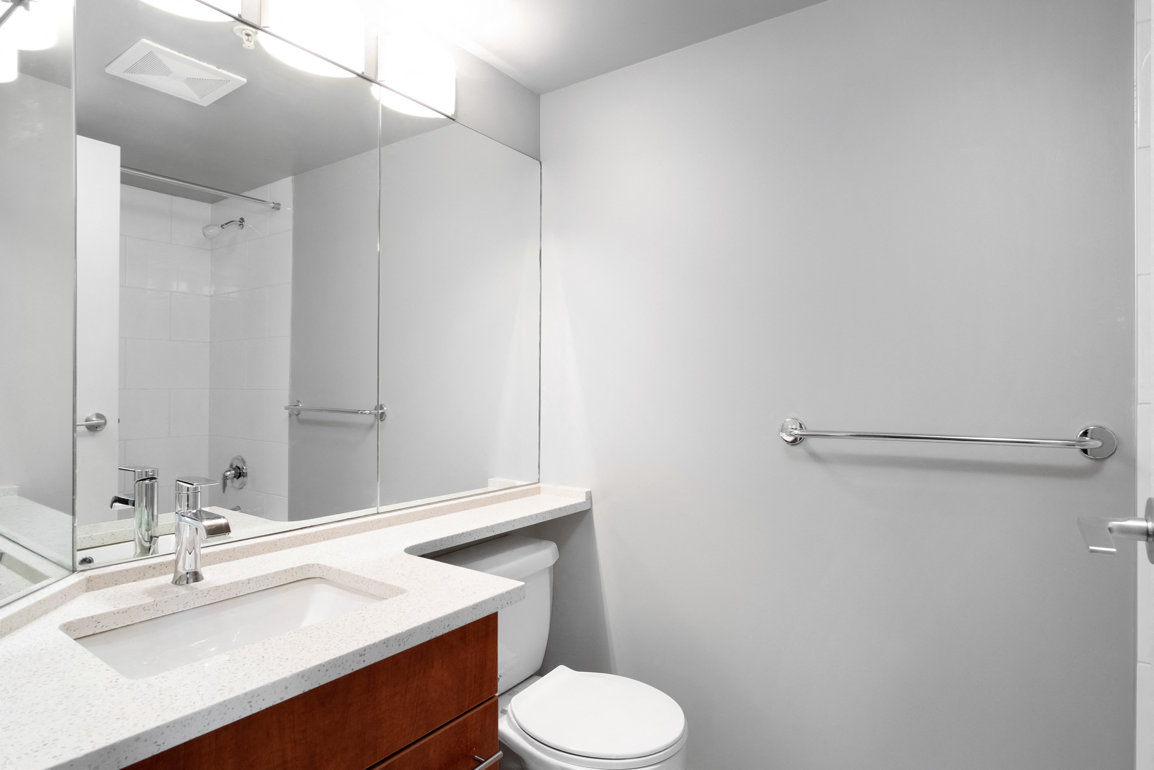 a bathroom with a mirror and a sink and a toilet