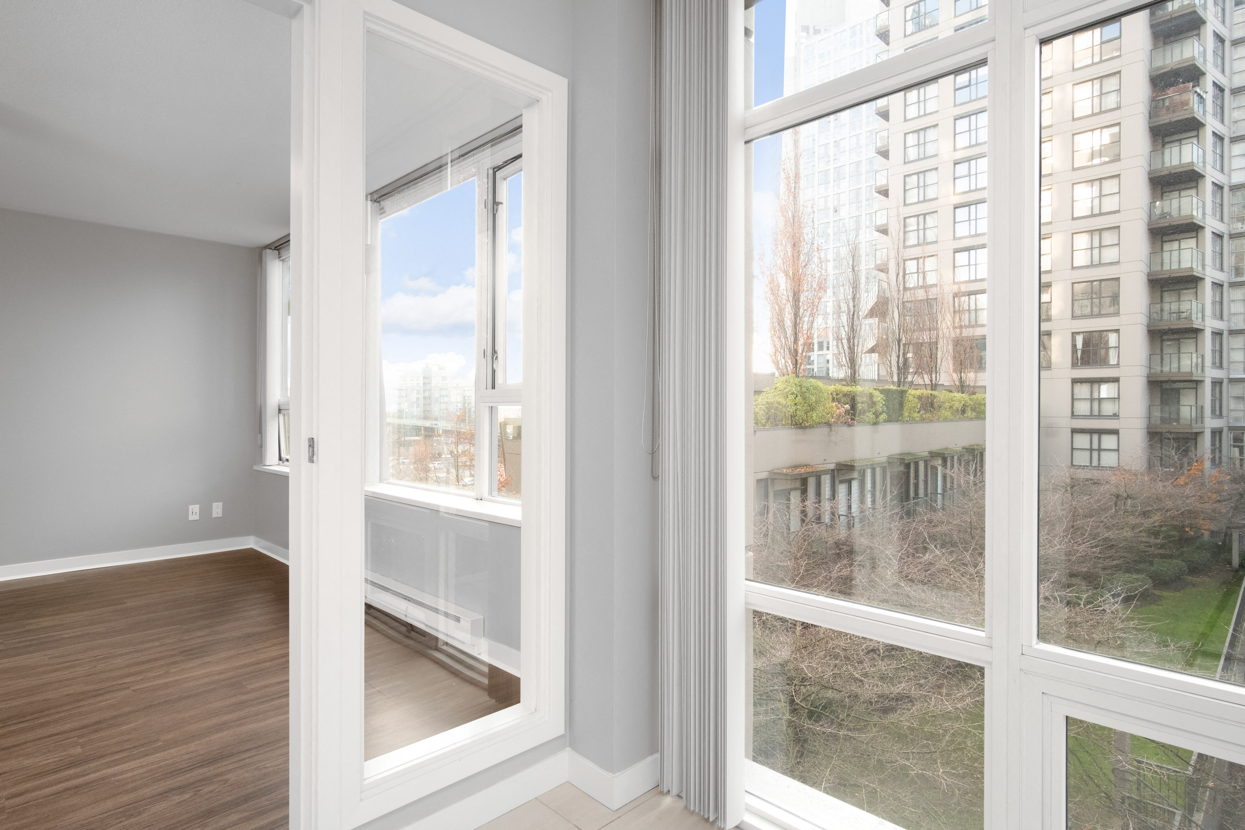 a living room with large windows and a view of the city