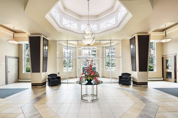 lobby with seating and a table with flowers. - Photo Gallery 6