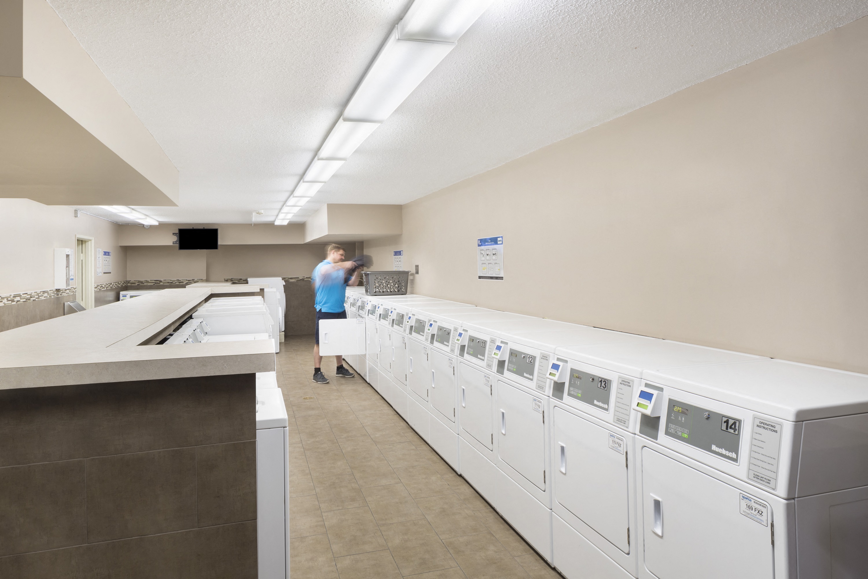 Shared laundry room with many washers and dryers