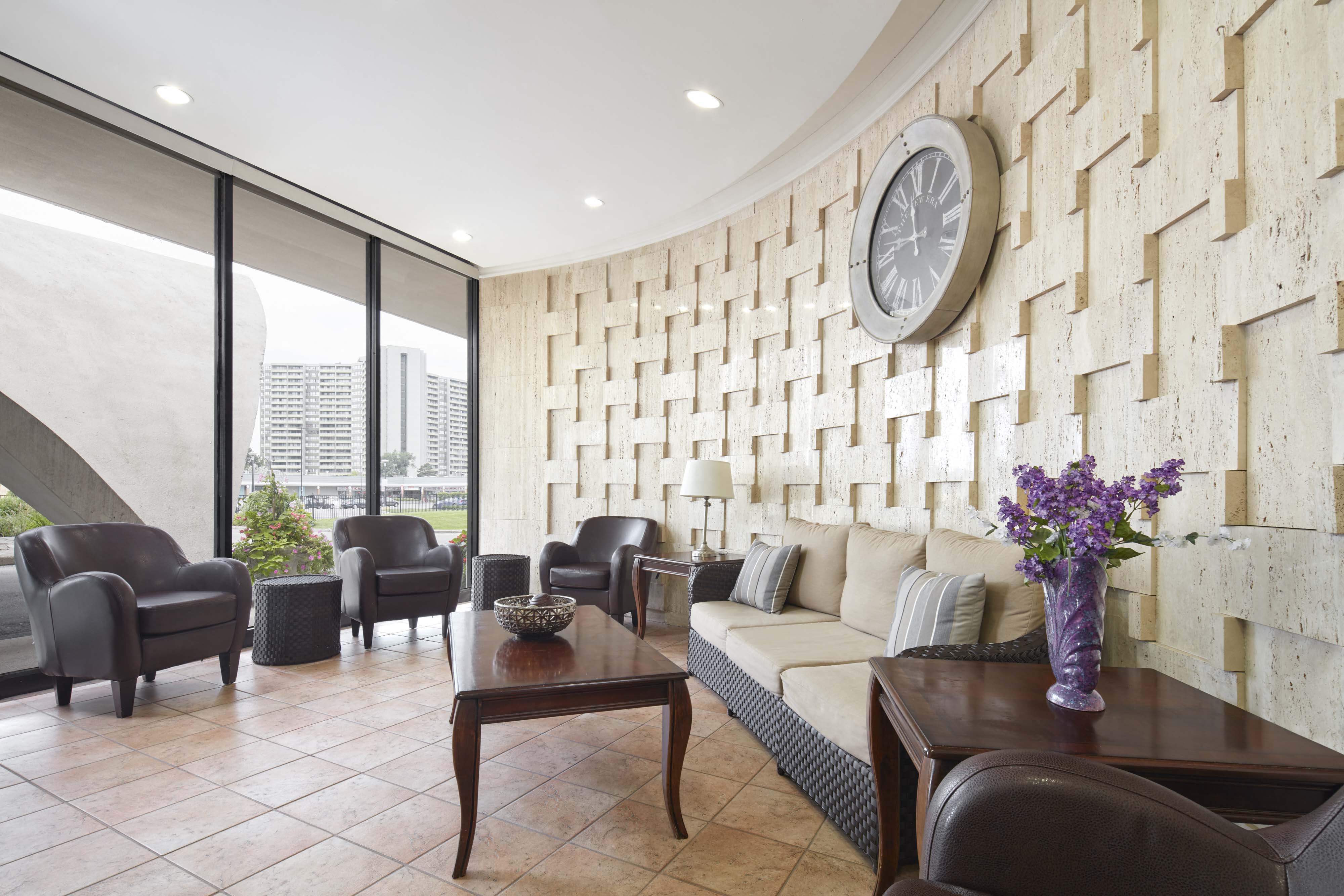a living room with a couch and a clock on the wall