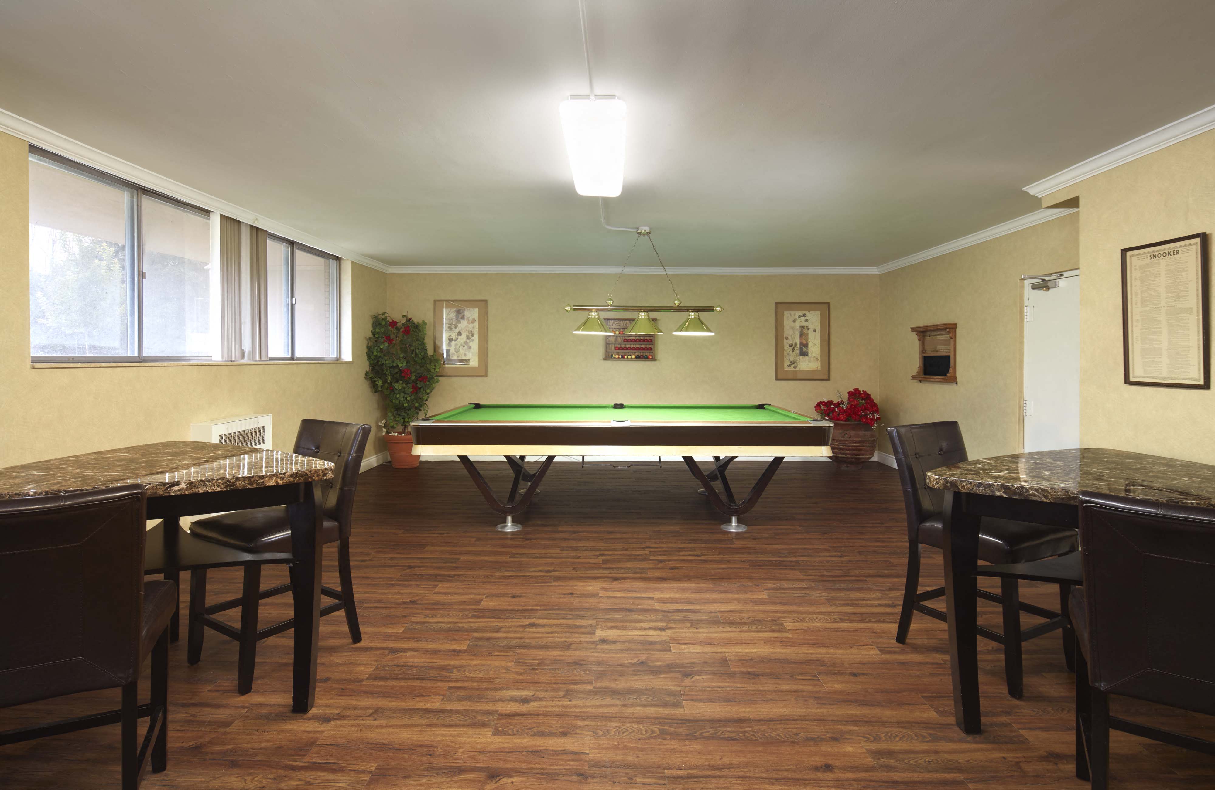 a game room with a pool table and tables
