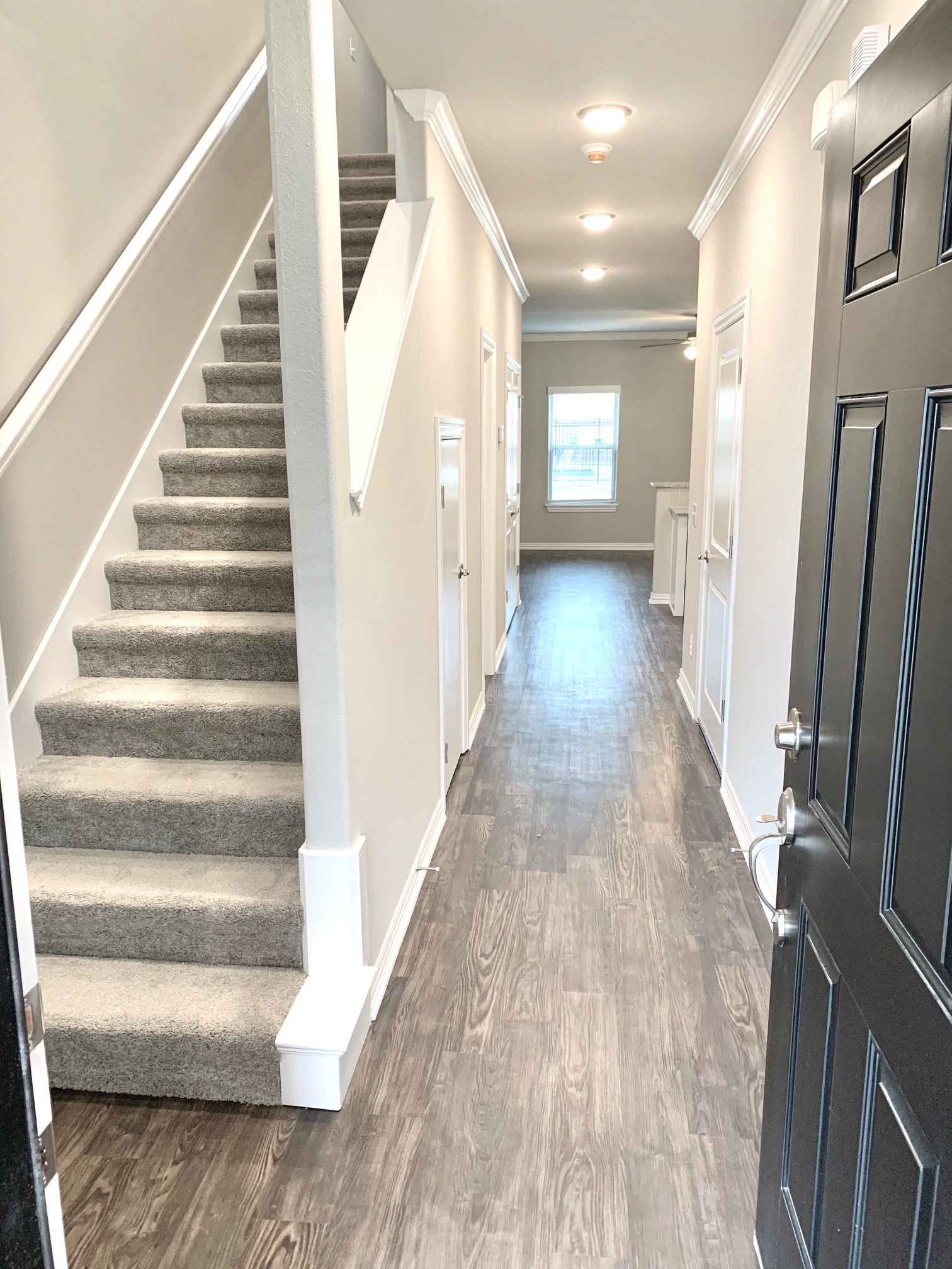 B1 (1-car) Entry with starcase facing front door, laminate wood flooring