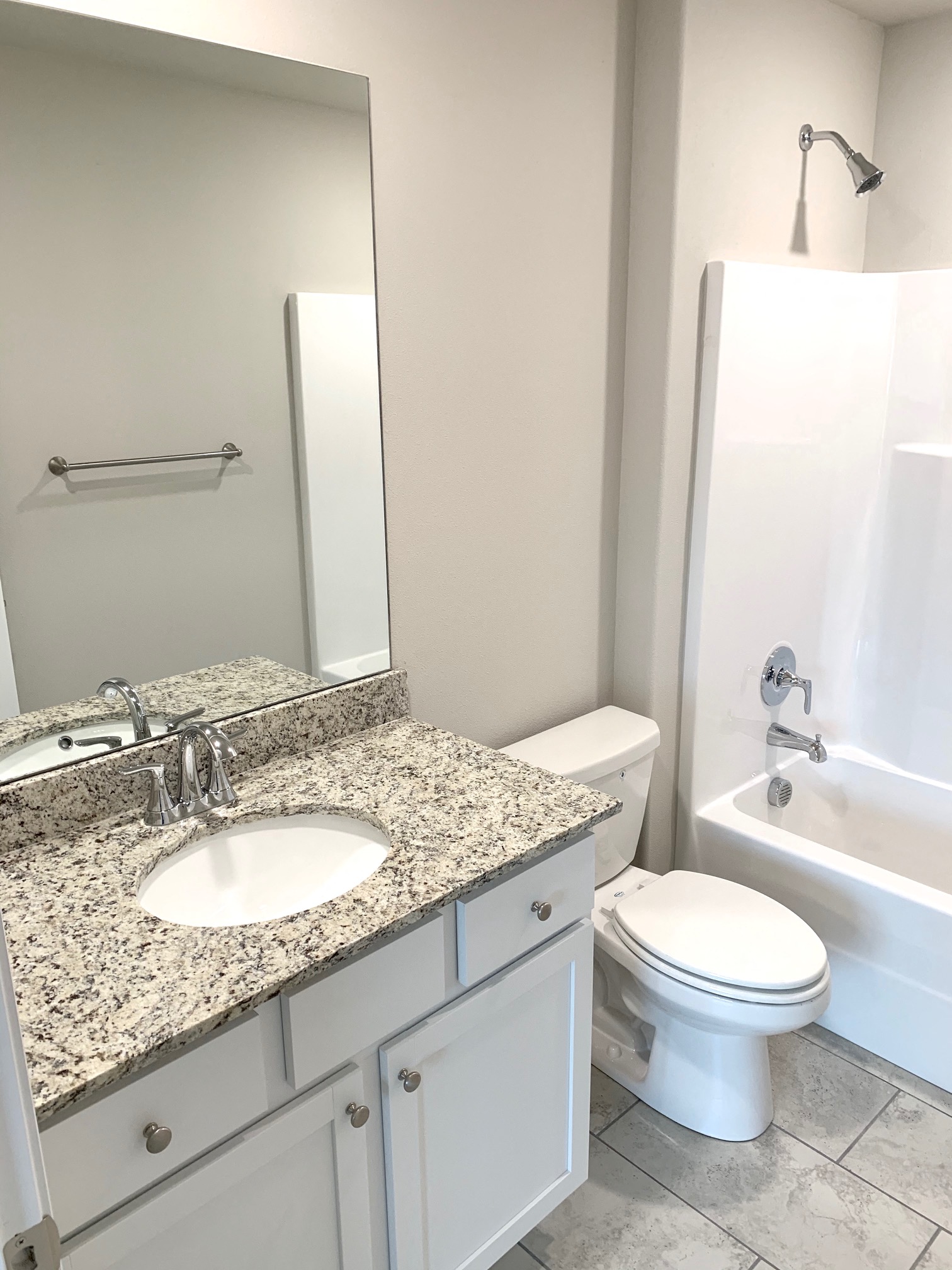 B1 (1-car) Guest Bath with sink, toilet, and shower, granite countertops