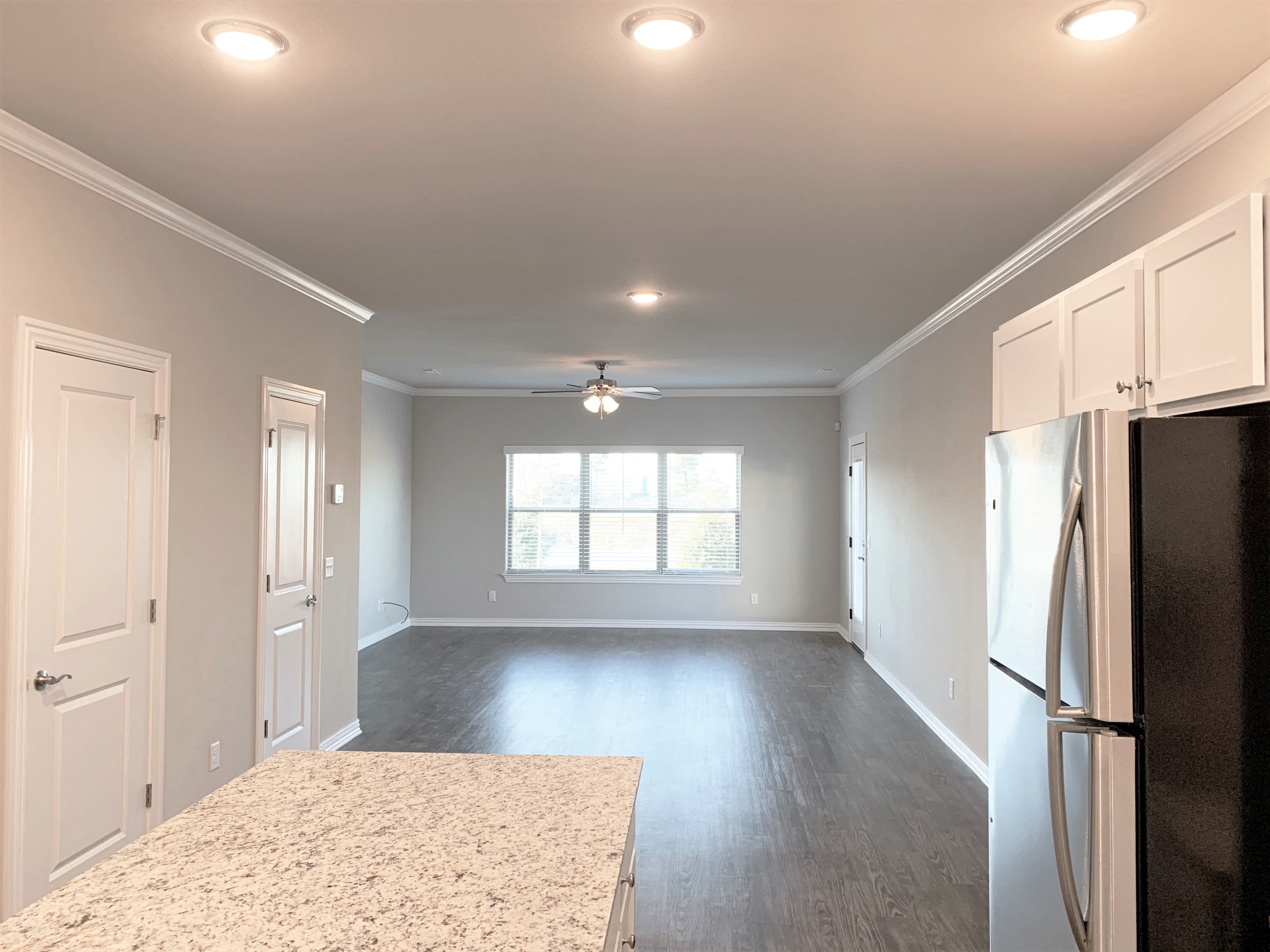 B2 (2-car) Downstairs open concept living and dining with laminate wood flooring