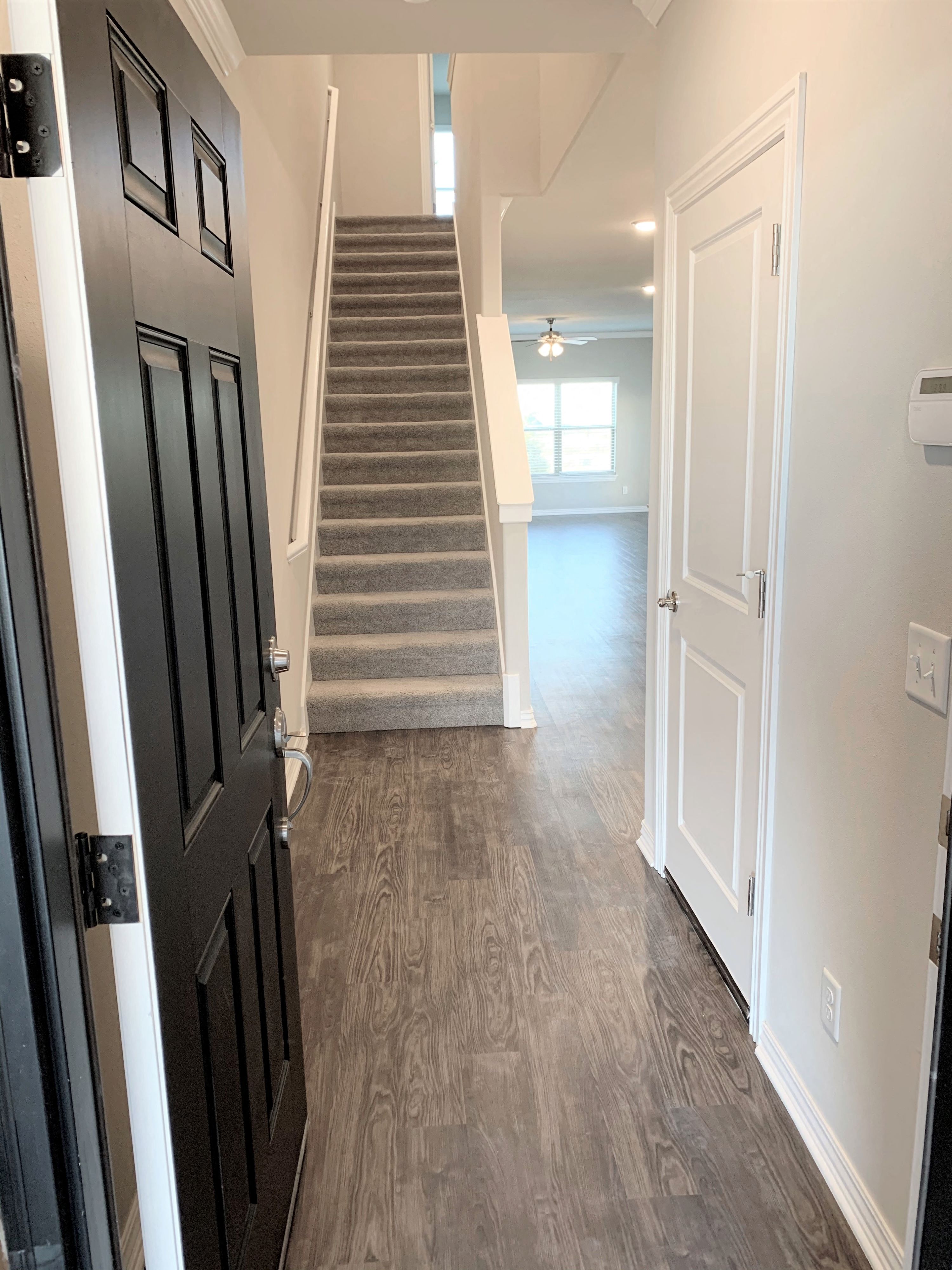 B2 (2-car) Entry with laminate wood flooring looking toward staircase