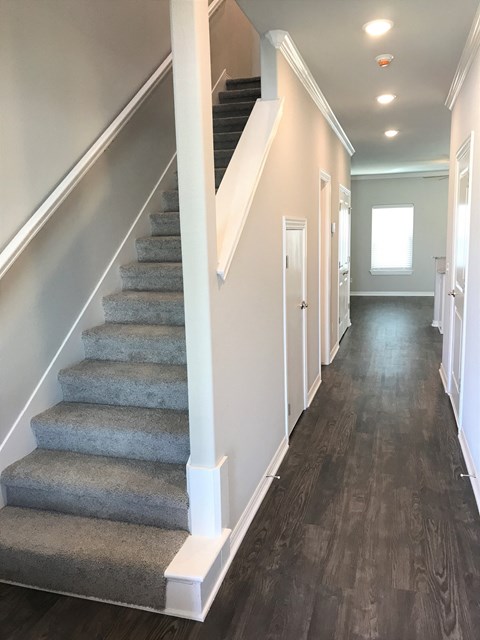 C1 (1-car) Entry with laminate wood flooring and staircase