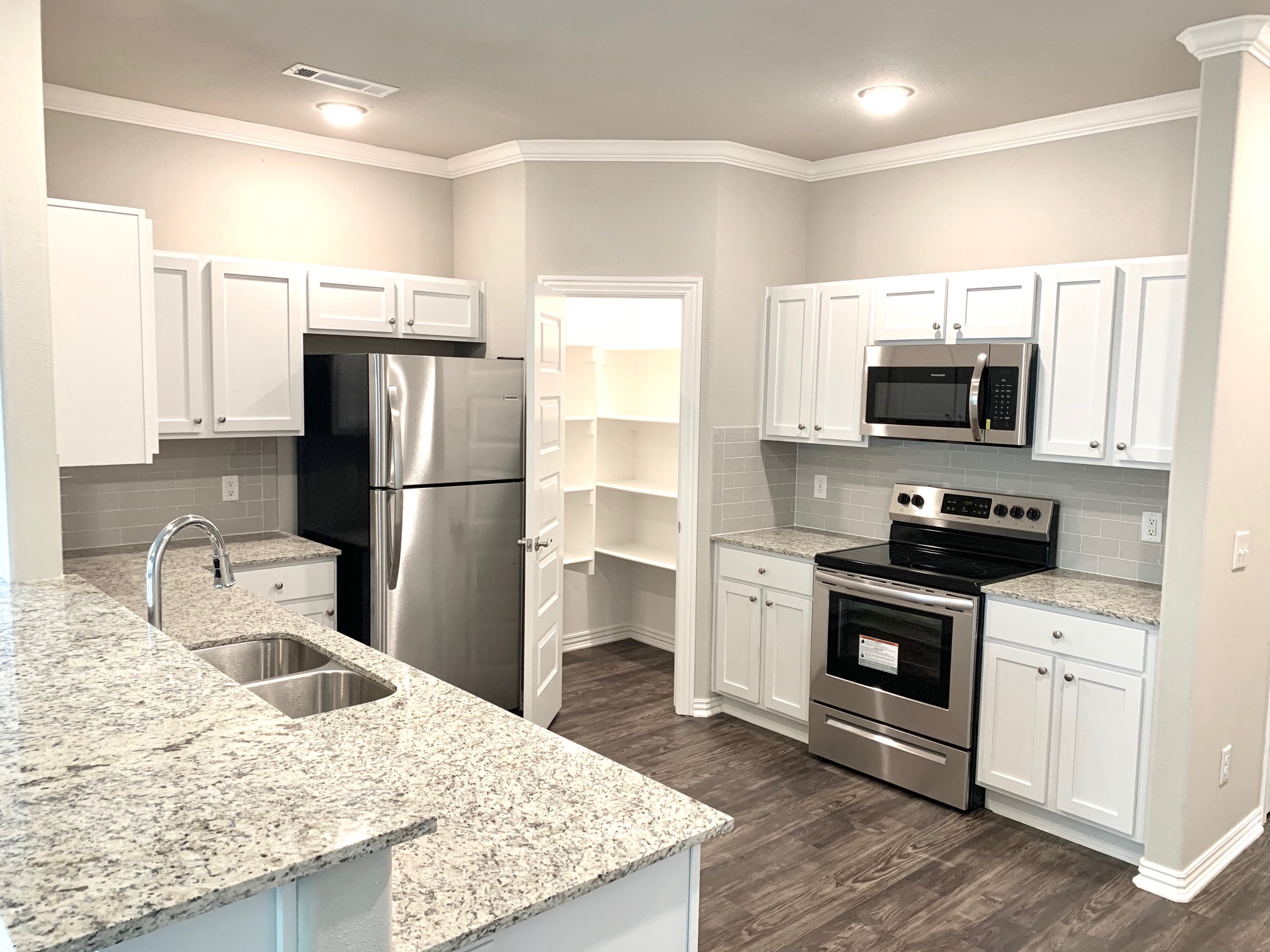 C1 Kitchen with raised bar, granite countertops, stainless steel appliances