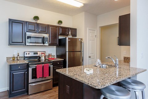 a kitchen with stainless steel appliances and granite counter tops