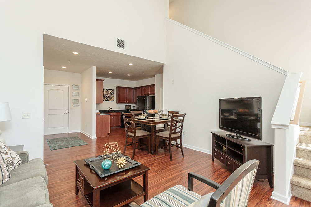 a living room with a couch and a table and a television