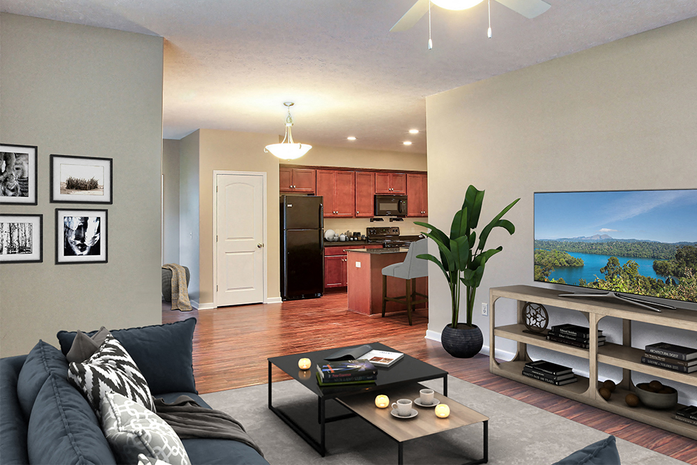 a living room with a couch and a coffee table in front of a kitchen