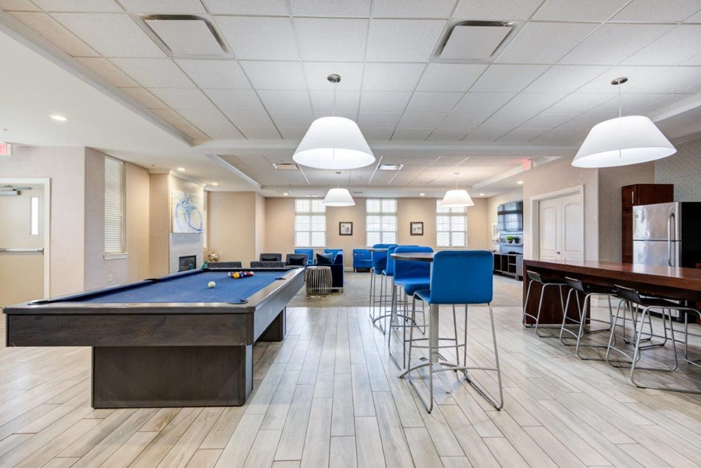 a game room with a pool table and bar