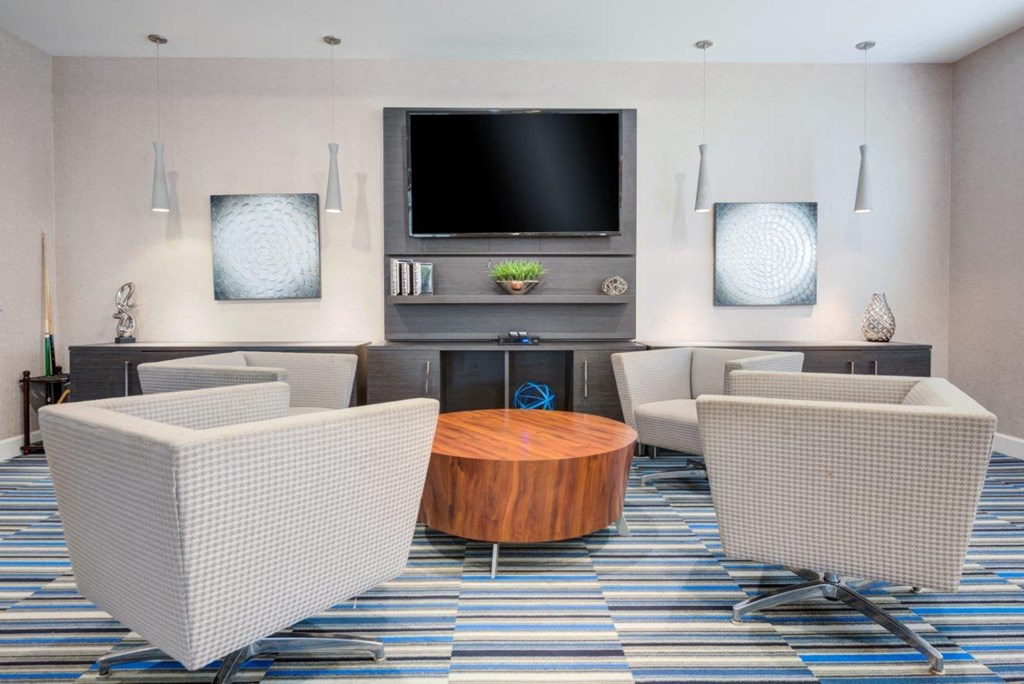 a living room with a table and chairs and a television