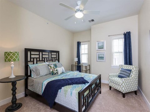 a bedroom with a bed and a ceiling fan