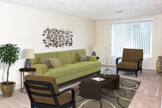 a living room with a green couch and two chairs