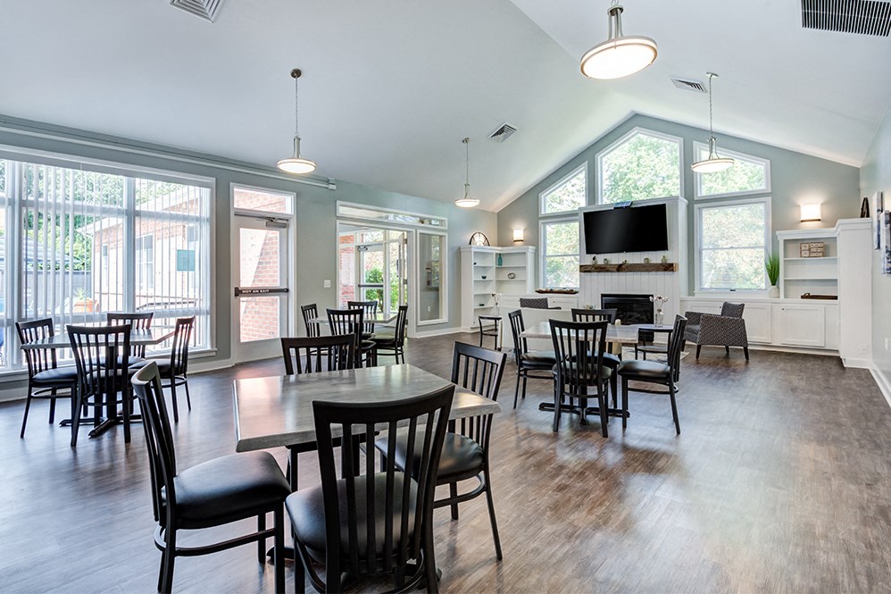 the dining room and living room of a home with a large table and chairs