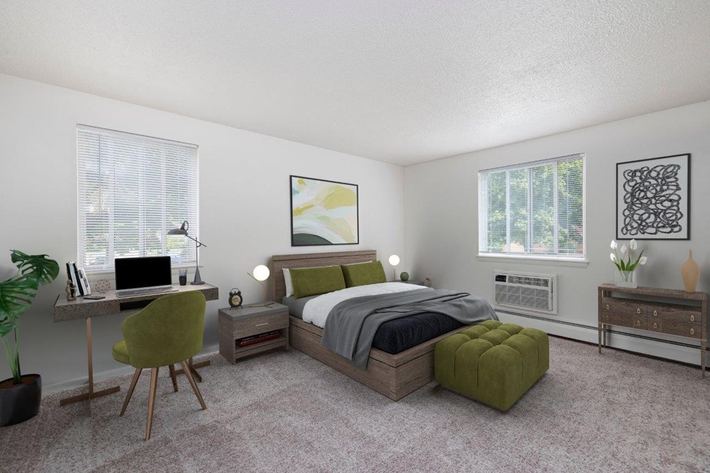 a bedroom with a bed and a desk with a computer