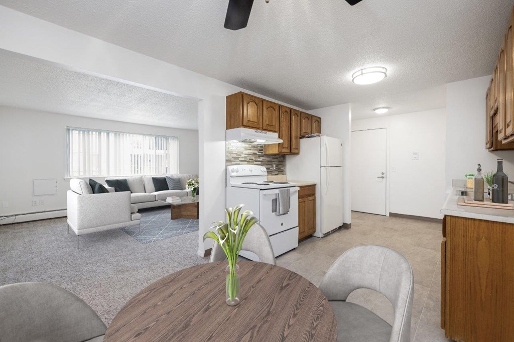 a kitchen and living room with a wooden table