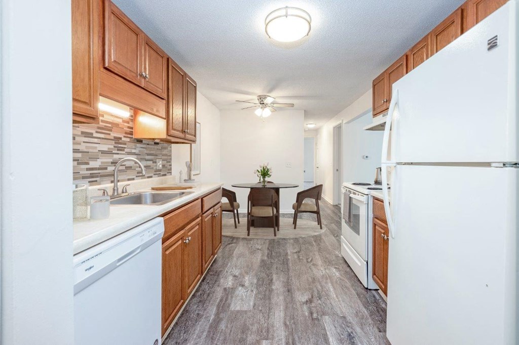 a kitchen with wooden cabinets and a white refrigerator