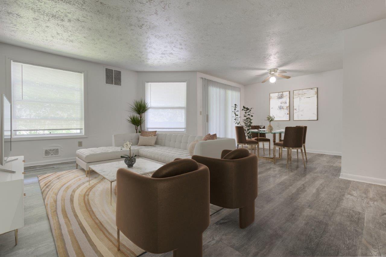 a living room and dining room with a couch and chairs