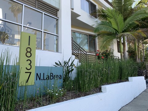 the facade of a building with a sign in front of it