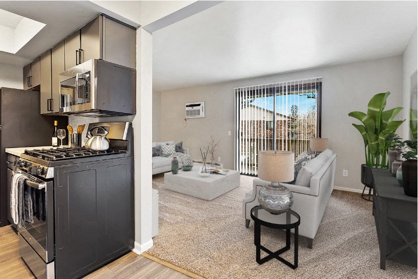 an open living room with a kitchen and a living room