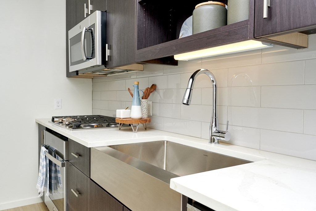 an empty kitchen with a sink and a faucet