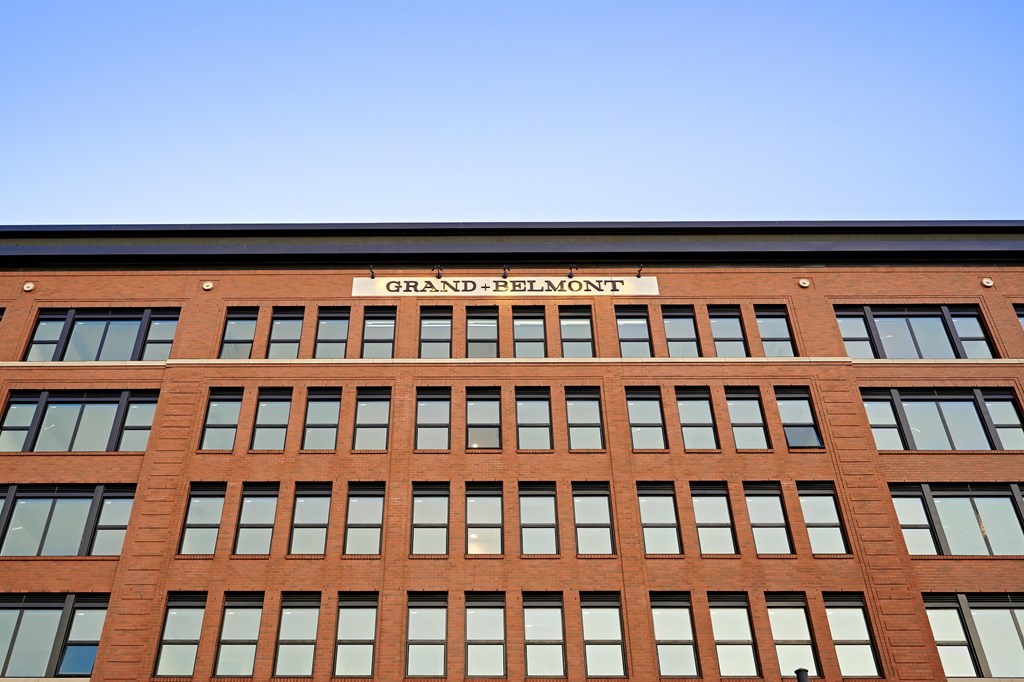 the front of a red brick building with a sign on top