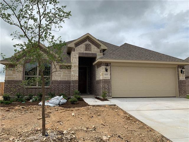 a brick house with a driveway and a garage door