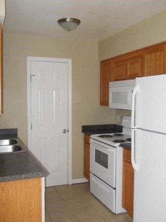 a kitchen with a stove refrigerator and a sink