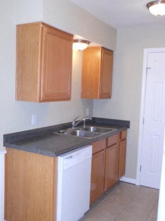 a small kitchen with a sink and a dishwasher