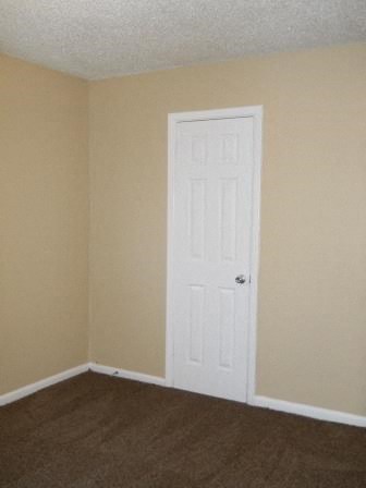 an empty room with a white door