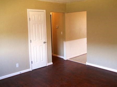 an empty living room with a white door