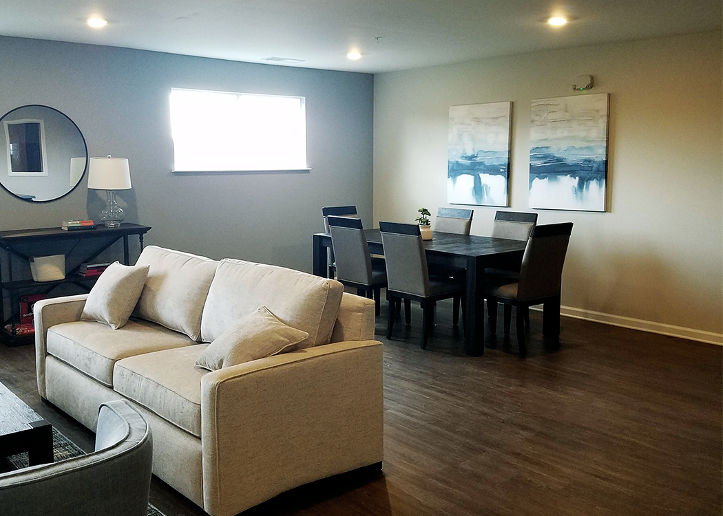 a living room and dining room with a couch and a table