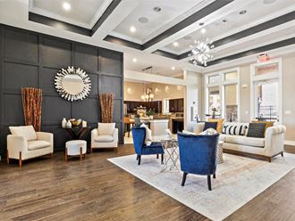 a living room with a couch and chairs and a table