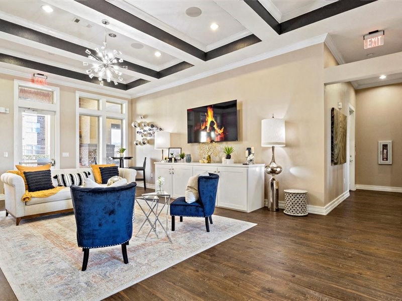 A living room with a blue chair and a white sofa.