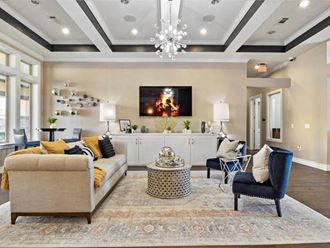 a living room with couches and chairs and a television