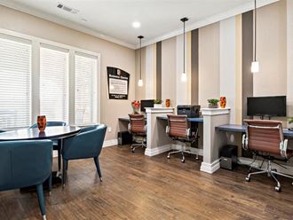 a conference room with three desks and chairs and a tv