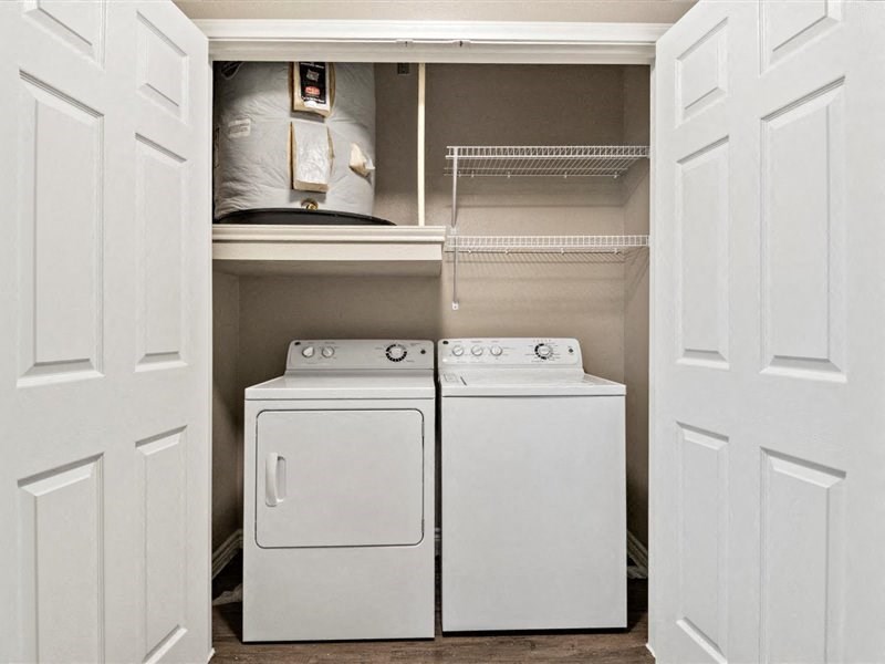 A white washing machine and dryer in a small laundry room.