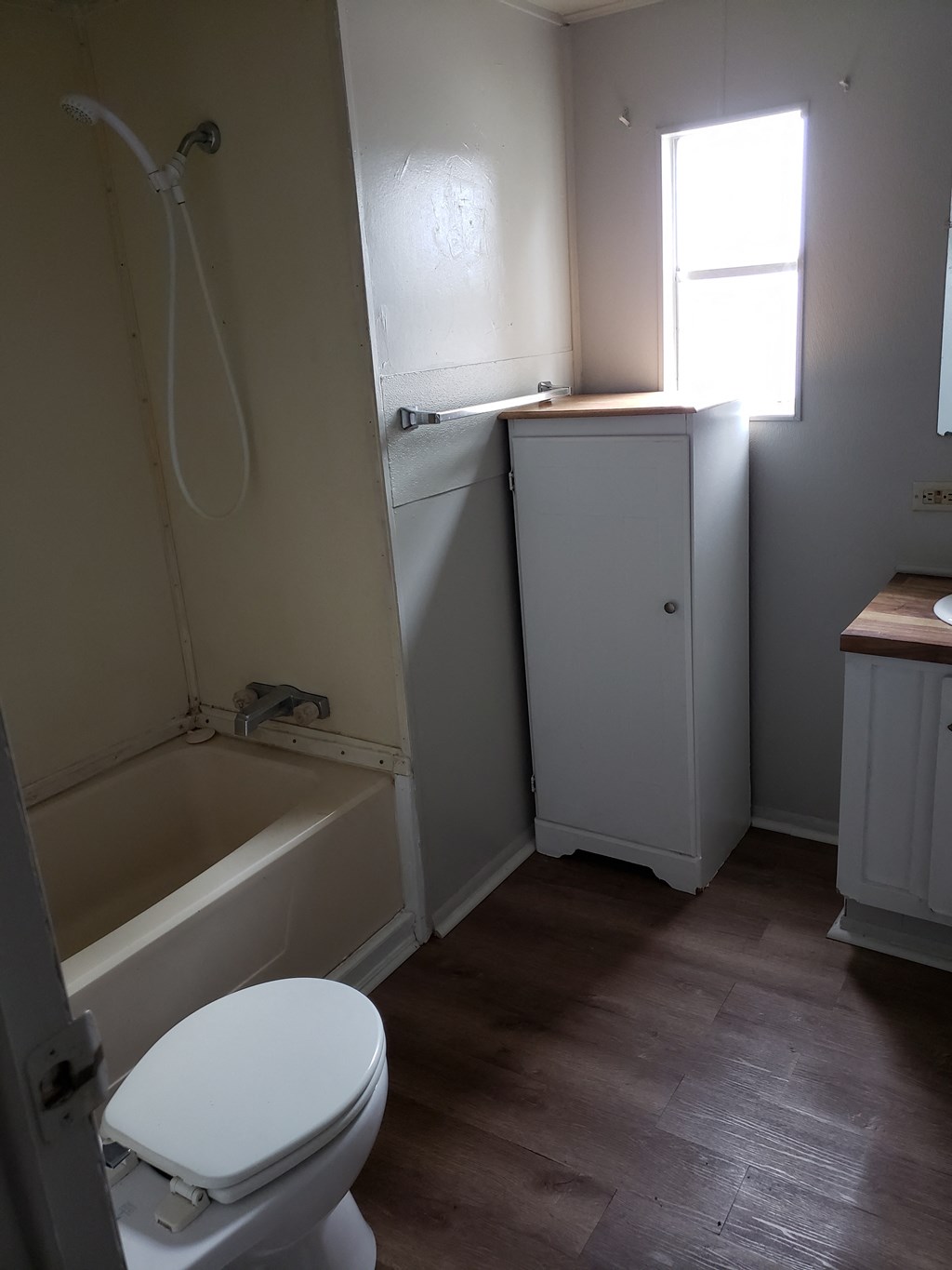 a small bathroom with a toilet and a bath tub