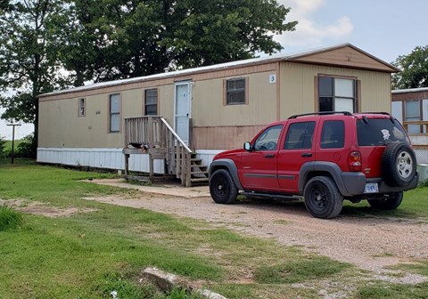 a house with a red truck parked in front of it