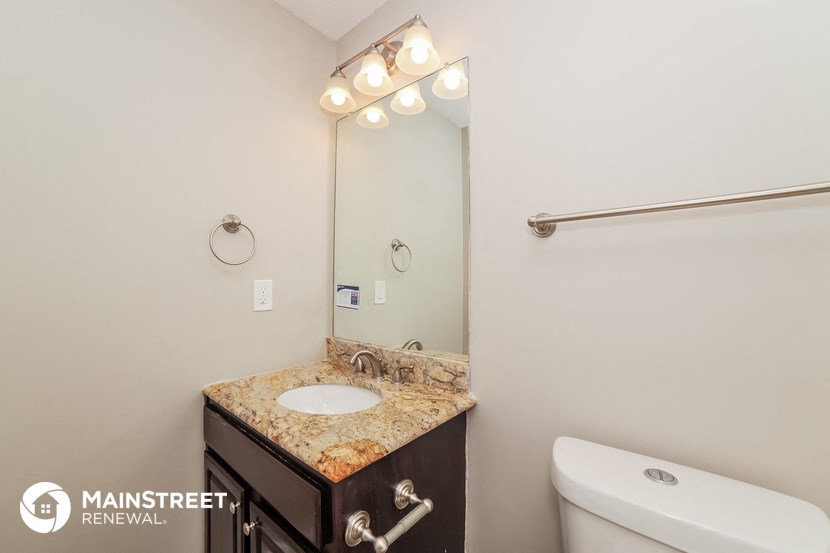a bathroom with a sink and a mirror and a toilet