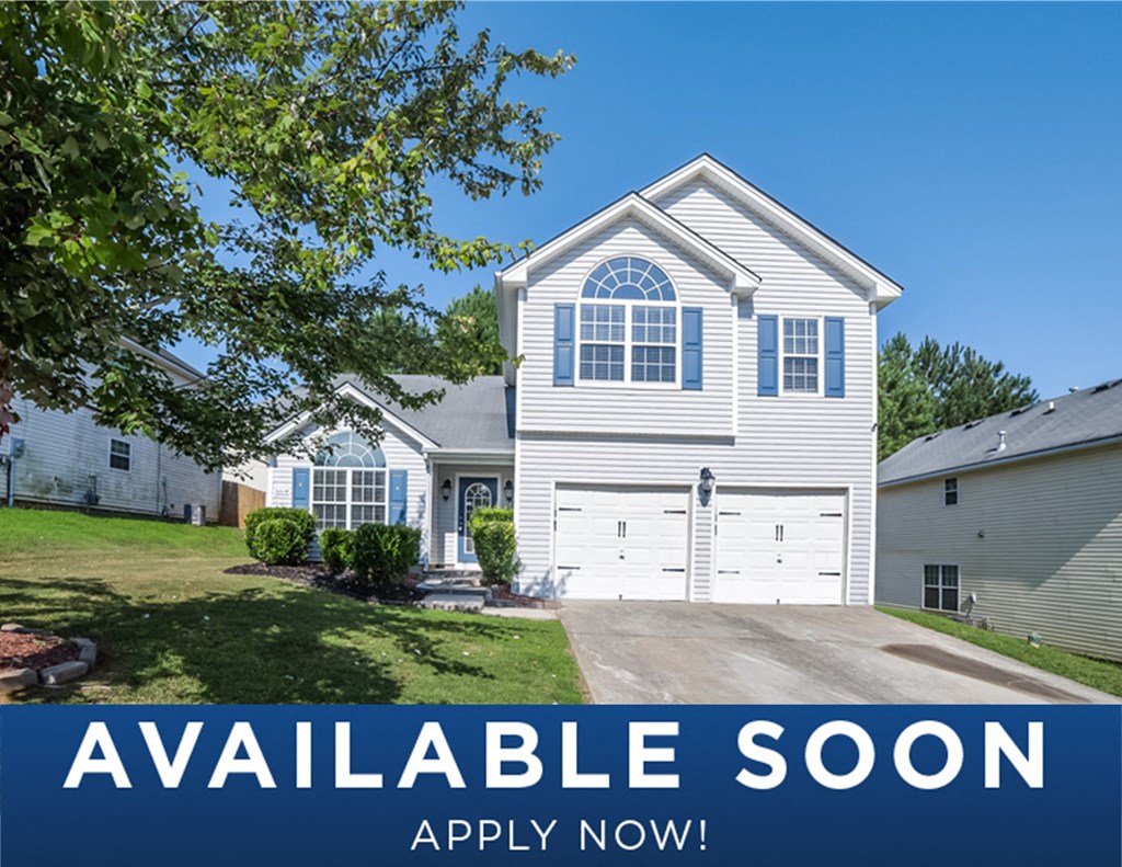 a white house with a lawn and a driveway