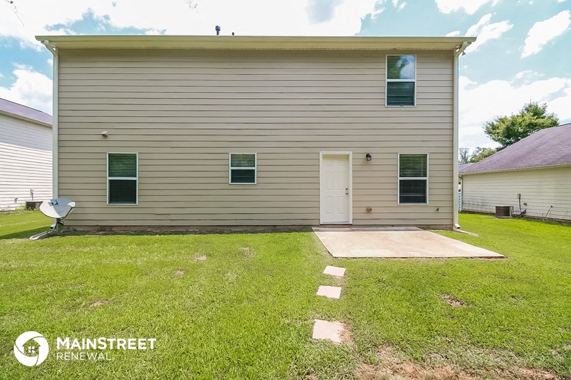 the front of a house with a yard and a driveway