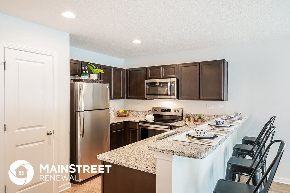 a kitchen with granite counter tops and stainless steel appliances