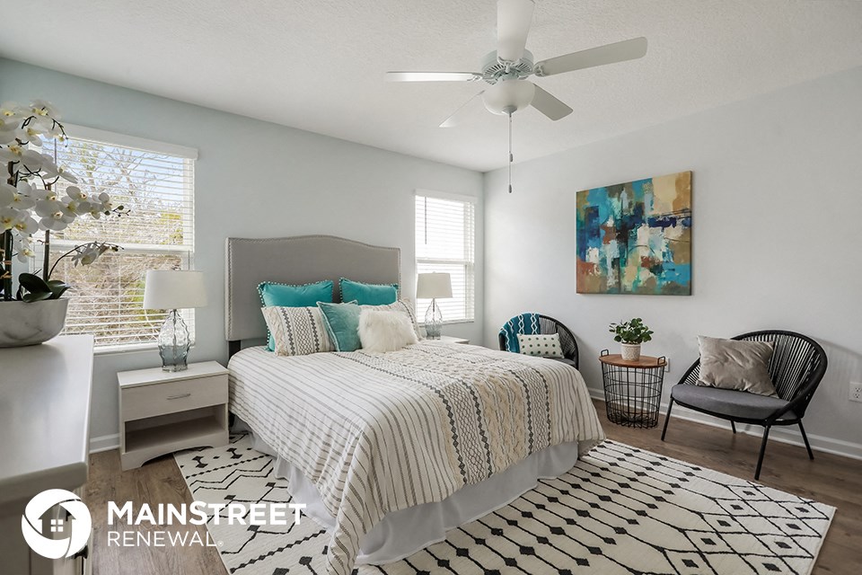 a bedroom with a bed and a ceiling fan