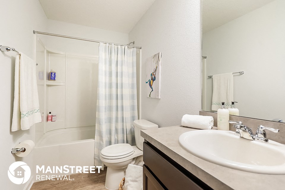 a bathroom with a sink and a toilet and a shower