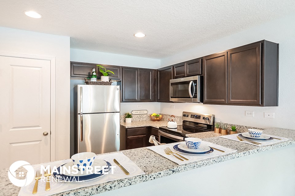 a kitchen with stainless steel appliances and granite counter tops
