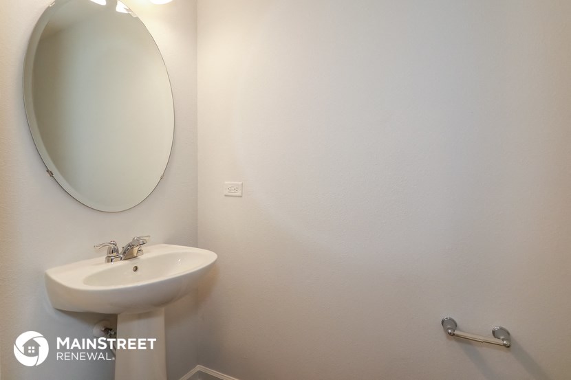 a small bathroom with a sink and a mirror